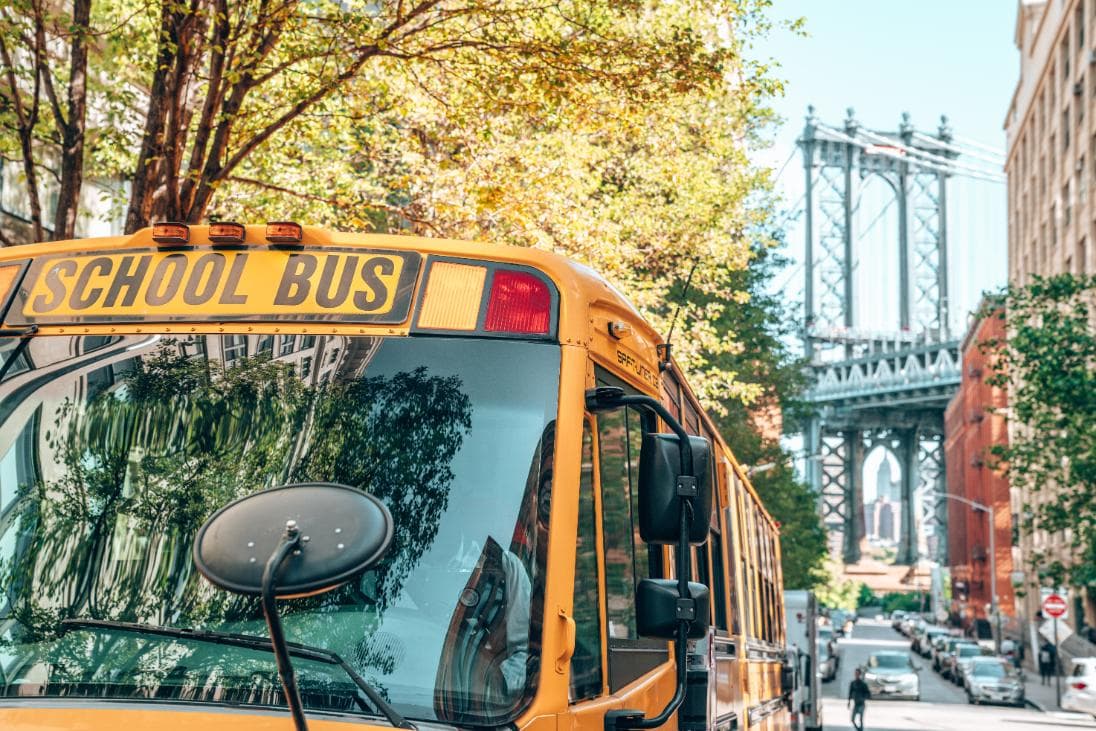 NYC School bus in front of Brooklyn Bridge