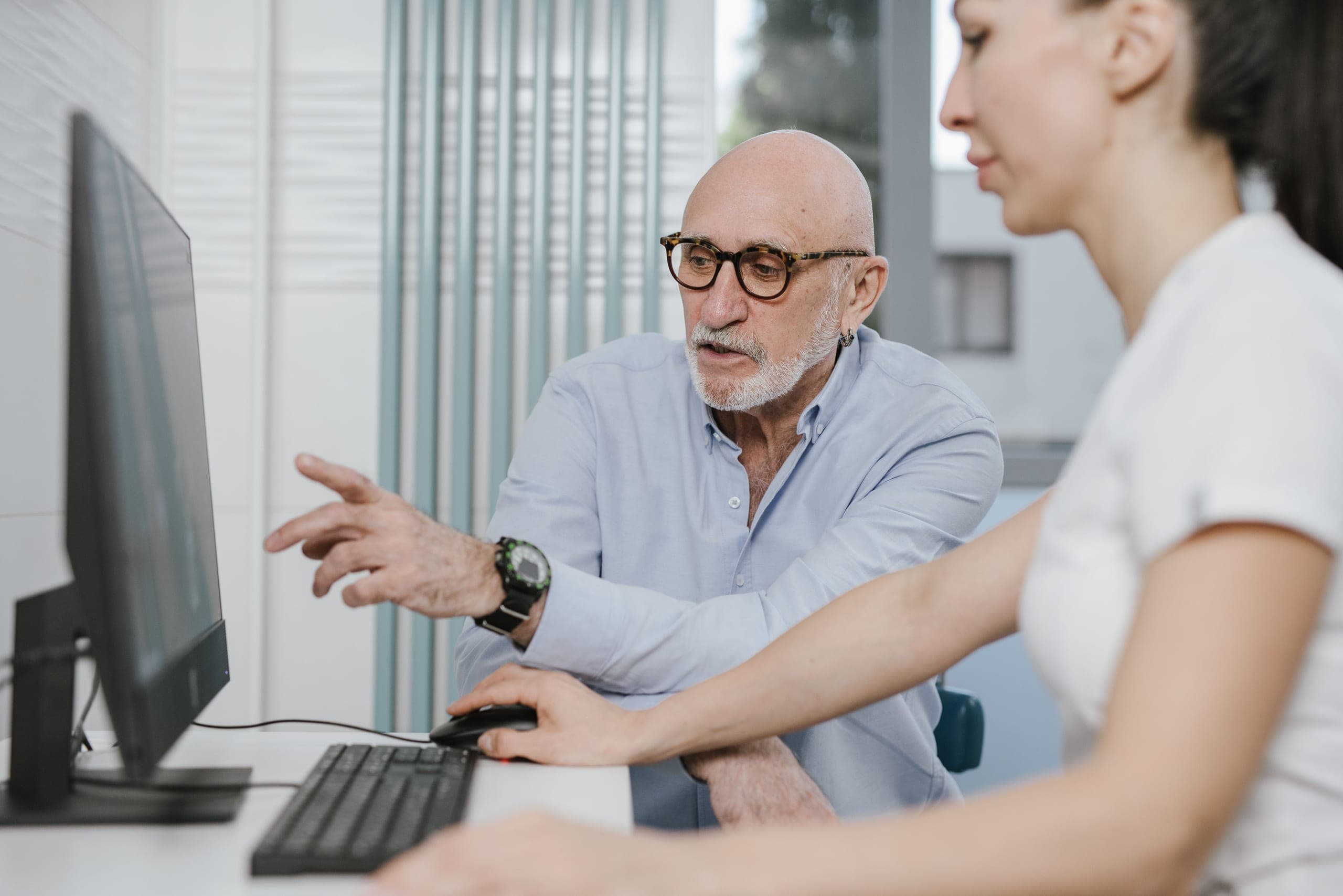 Image of male and female HR team reviewing activity in Fastvue Reporter