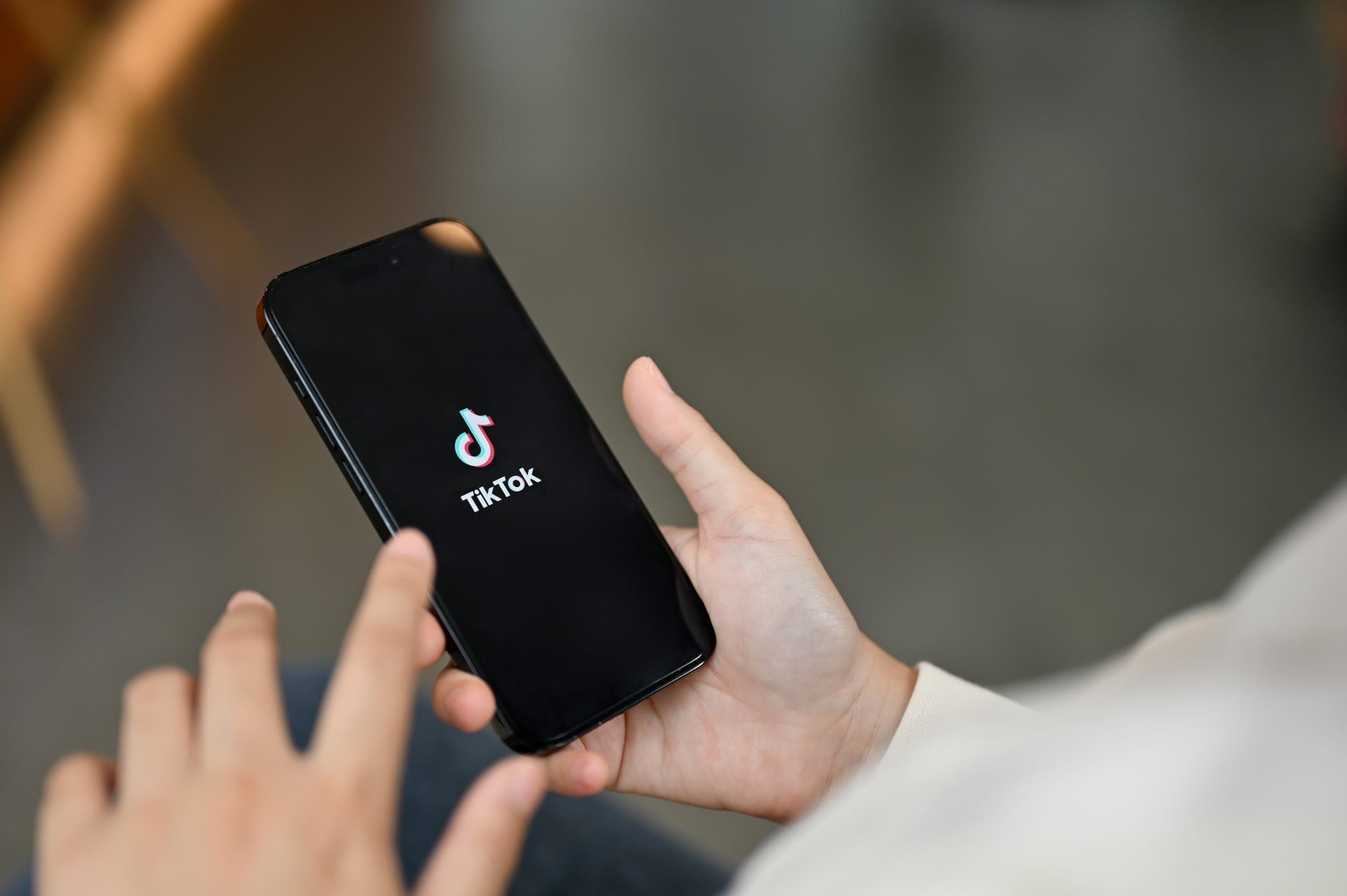 Image of a child opening the TikTok app on their phone
